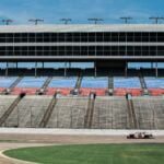 aerial photography of car on stadium under clear blue sky